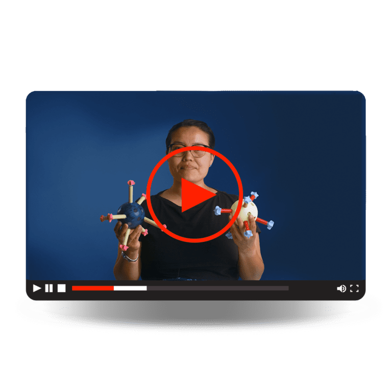 Subunit Vaccines Video - A woman holding models of virus structures.