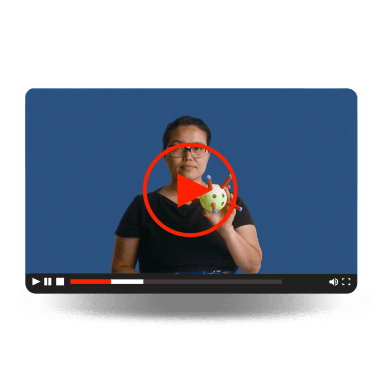 Vector Vaccines Video - A woman holding a single virus structure model.